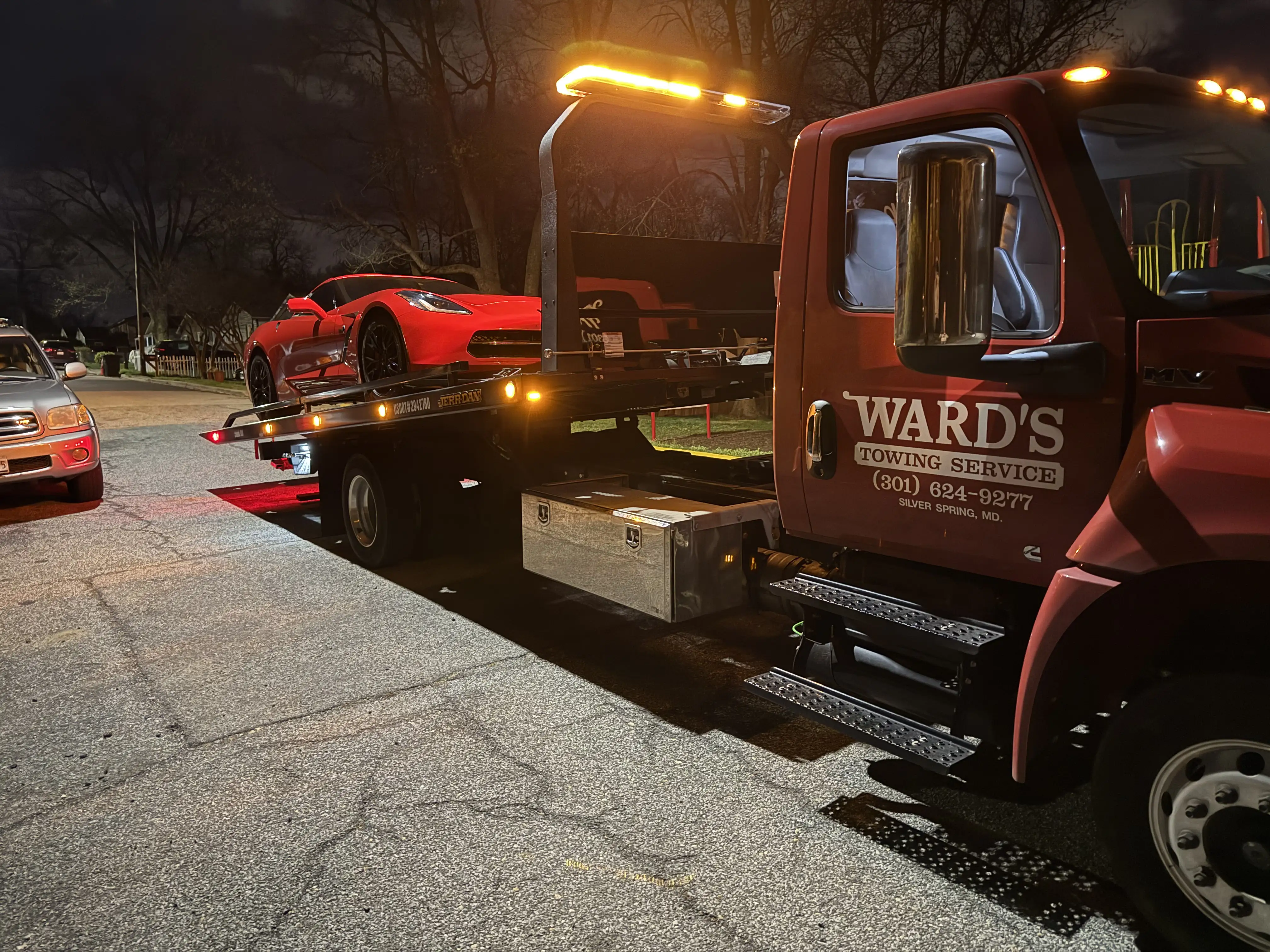 Tow truck on the road at night, Dave Ward's Towing